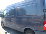 a blue van that is parked in a parking lot
