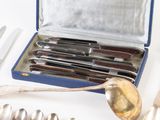 a box of silverware with spoons and knives in it