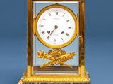 a gold and marble clock with a bird on it