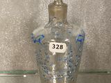 a glass bottle with a number on it sitting on a glass shelf
