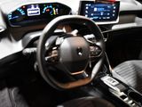 the interior of a car with a steering wheel, dashboard, and display screen