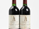 two bottles of wine sitting next to each other on a white surface