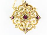 an image of a gold and garnett necklace on a white background