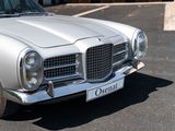 a silver car that is parked in a parking lot