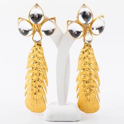 pair of gold tone earrings with black and white stones