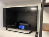 a flat screen tv sitting on a shelf in a room