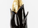 a black and gold vase with a corn on it
