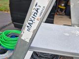 a ladder with a sign on it sitting in the back of a truck