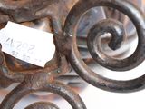 a close up of a wrought iron bench with a price tag on it