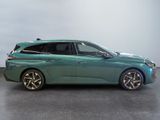 the green car is parked on the concrete floor in the room