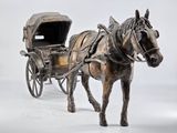 statue of a horse pulling a carriage with a covered seat