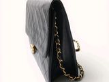 a close up of a black purse on a white background