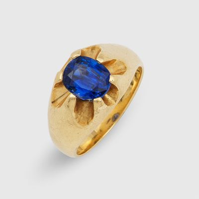 a gold ring with a blue sapphire stone in the center