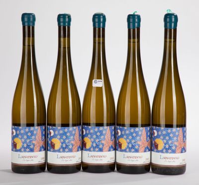 four bottles of wine are lined up on a white surface