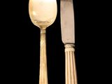 two spoons and a knife sitting next to each other