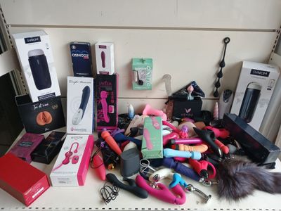 a lot of different items on a shelf in the room