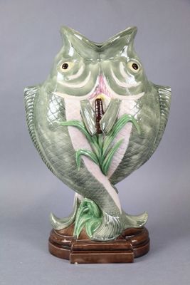 une figurine de chouette verte tenant une fleur dans le bec