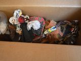 a cardboard box filled with assorted clothing and a plastic cup