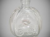 a clear glass bottle with a ring inside of it