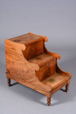 an antique wooden step stool with two steps on each side