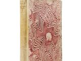 an old book with a red and white design on it