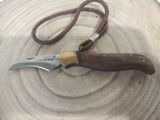 a knife that is laying on top of a wooden plate