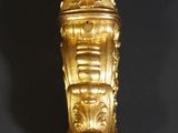 a gold statue of a man with a lion head on it ' s head