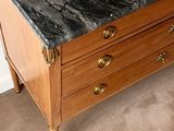 a black marble top on a wooden dresser in a room