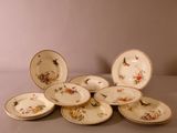 a pile of plates with birds on them on a table