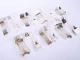 many forks and spoons laid out on a table