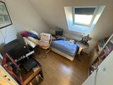 a small room with a bed and a desk in it