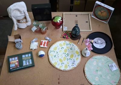 a wooden table with various items on it and a clock