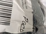 a person holding a plastic bag with a label on it