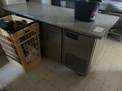 an image of a kitchen with a counter top and a trash can