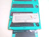 four boxes of computer keyboards are stacked on top of each other