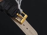 a close up of a person ' s hand holding a black leather watch strap