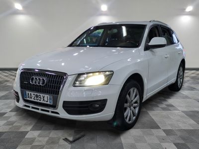 the white audi suv is parked in a large room