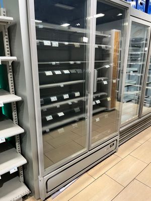 many empty shelves in a store that are full of items
