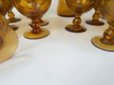 a lot of gold goblets sitting on a table