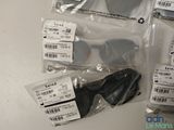 several pairs of sunglasses are wrapped in plastic bags on a table