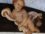 a figurine of a little boy sitting on a table