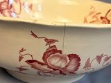 a white bowl with a red floral design on it