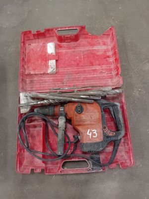 a red tool case with a hammer and other tools in it