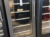 two refrigerators that are sitting side by side in a store