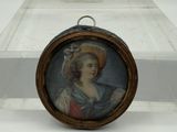 a miniature picture of a woman in a hat on display