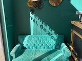 a couch and a chair in a room with green walls
