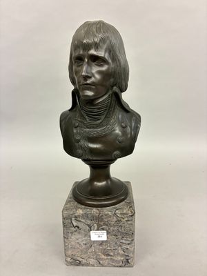 a bronze bust of a man with long hair on a marble base