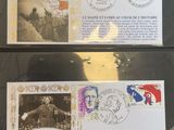 two stamps with pictures of people on them on a table