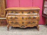 an antique chest of drawers in a room with a pink wall in the background