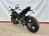 a picture of a motorcycle parked in front of a white backdrop